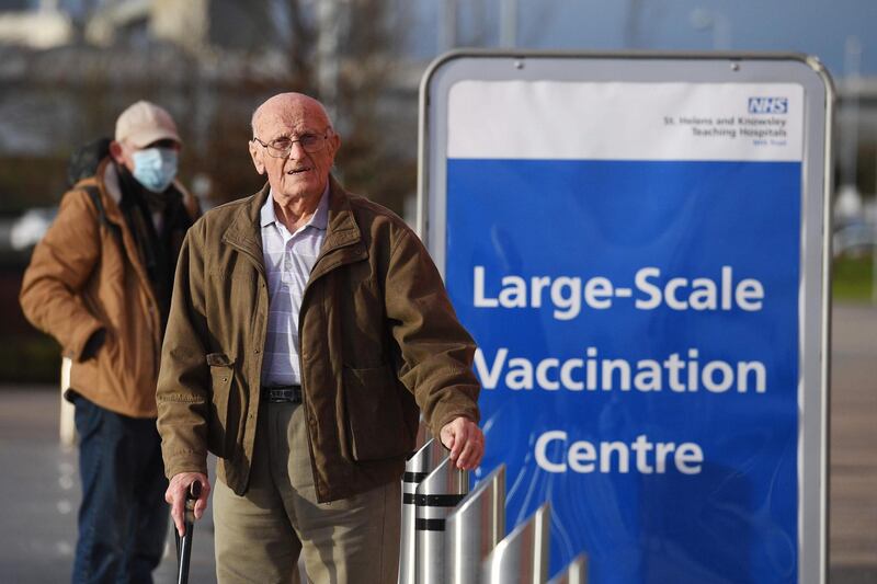 People arrive at Totally Wicked Stadium home of St Helen's rugby club as it opens as a Covid-19 mass vaccination centre in St Helen's, northwest England on January 18, 2021. AFP