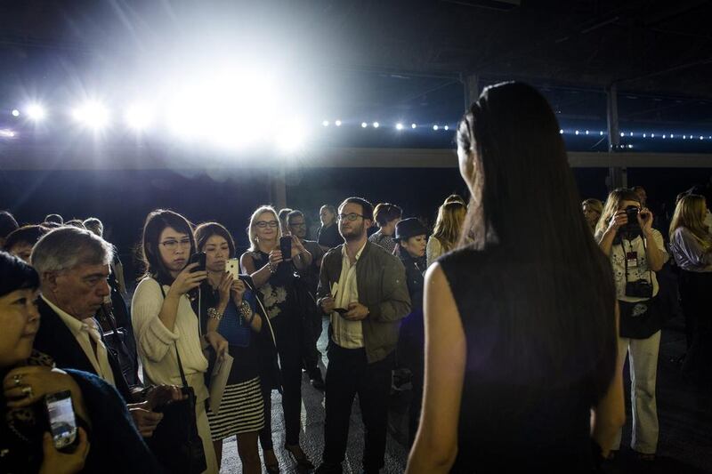 Guests take photographs of Qiwen Feng, right, at the end of the Dries Van Noten fashion show. Yoan Valat / EPA