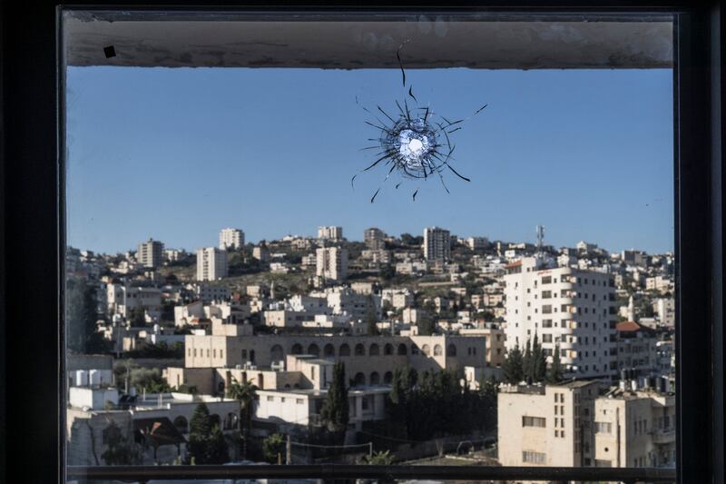 A hole from a stray bullet in the window of a hotel room in the West Bank city of Jenin. AFP