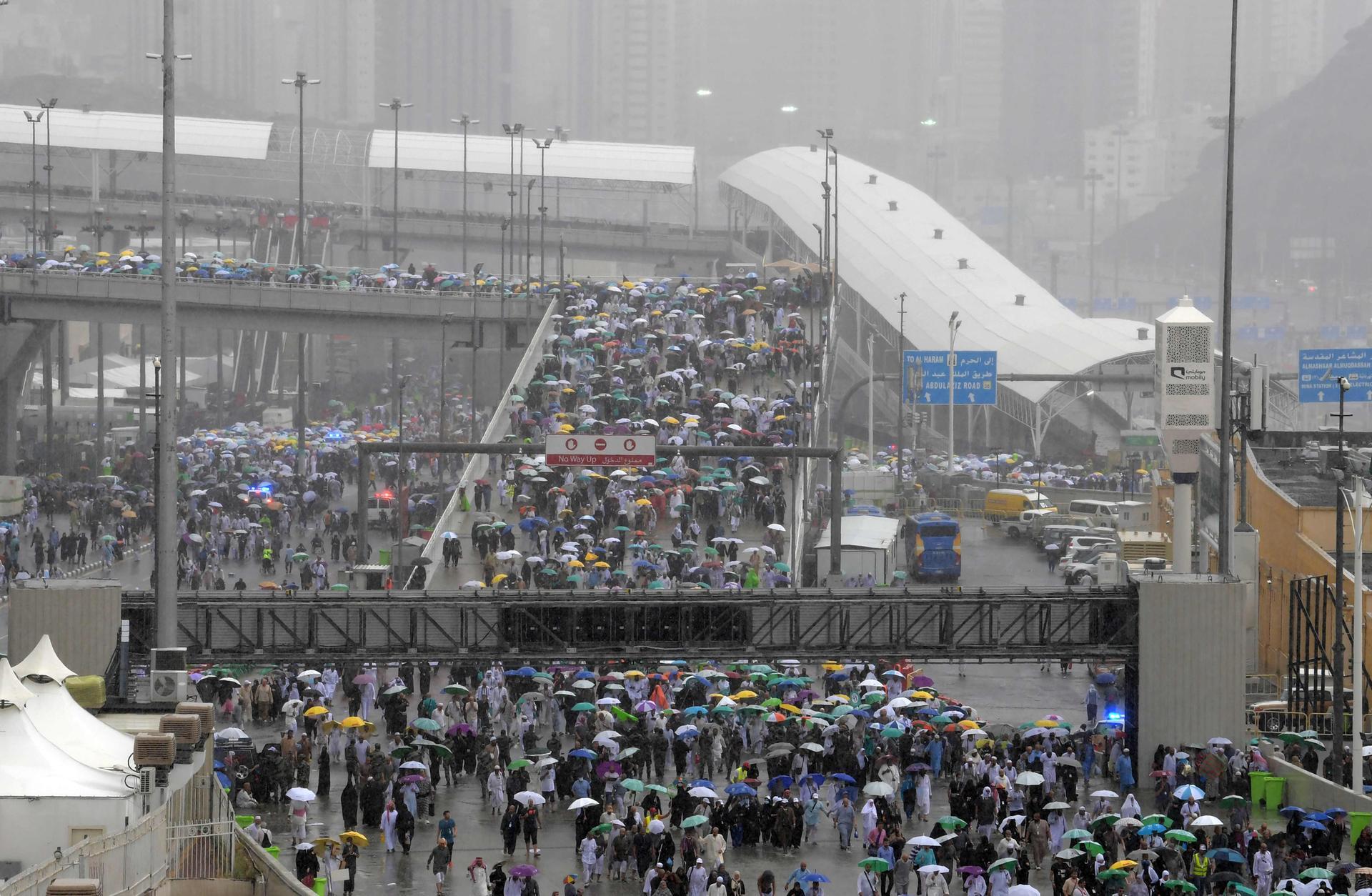 Muslim worshippers arrive in Mina under heavy rain to throw pebbles as part of the symbolic Jamrat Al Aqabah. AFP