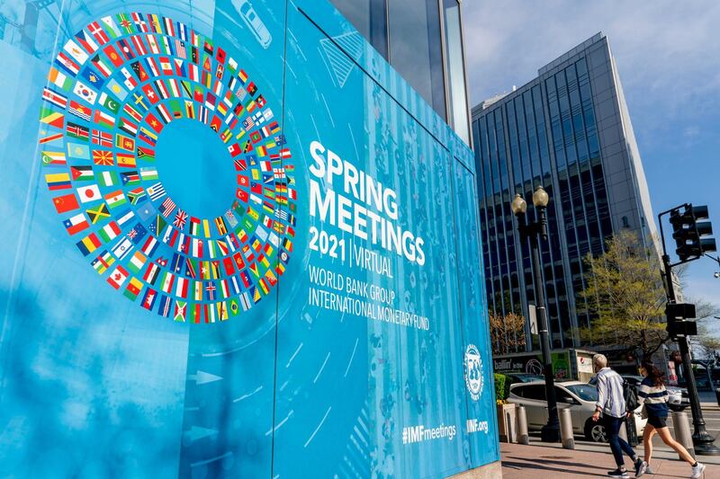 A poster is displayed on the International Monetary Fund building, Monday, April 5, 2021, in Washington. The IMF and the World Bank open their virtual spring meeting. (AP Photo/Andrew Harnik)