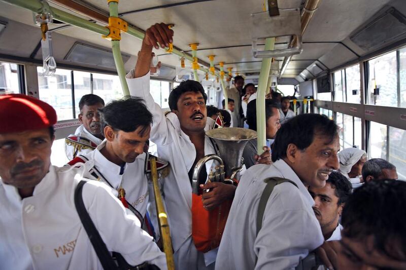 In this September 24, 2014, photo, members of Master Band travel on the bus to work in New Delhi, India. Manish Swarup/AP Photo