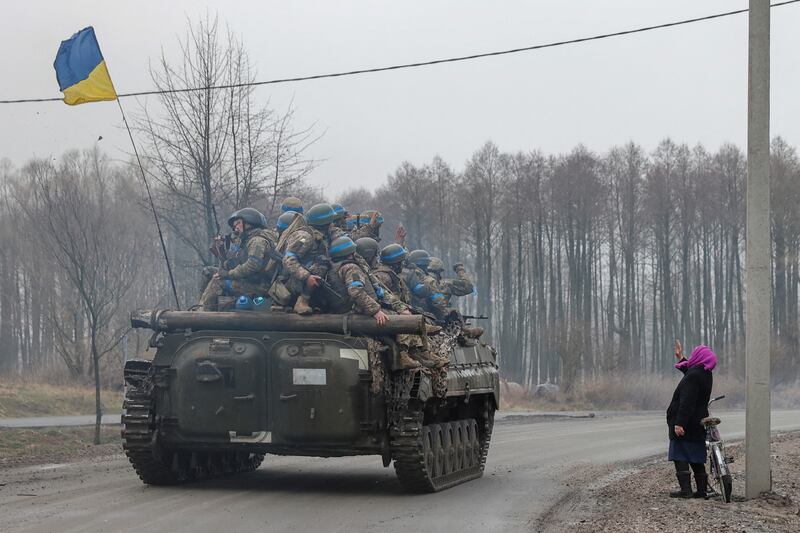 A local woman salutes Ukrainian soldiers in the Chernihiv region. Reuters