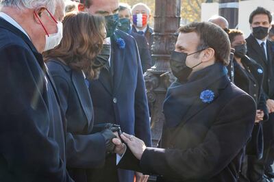 French President Emmanuel Macron shakes hands with US Vice President Kamala Harris at the Arc de Triomphe in Paris. AFP 