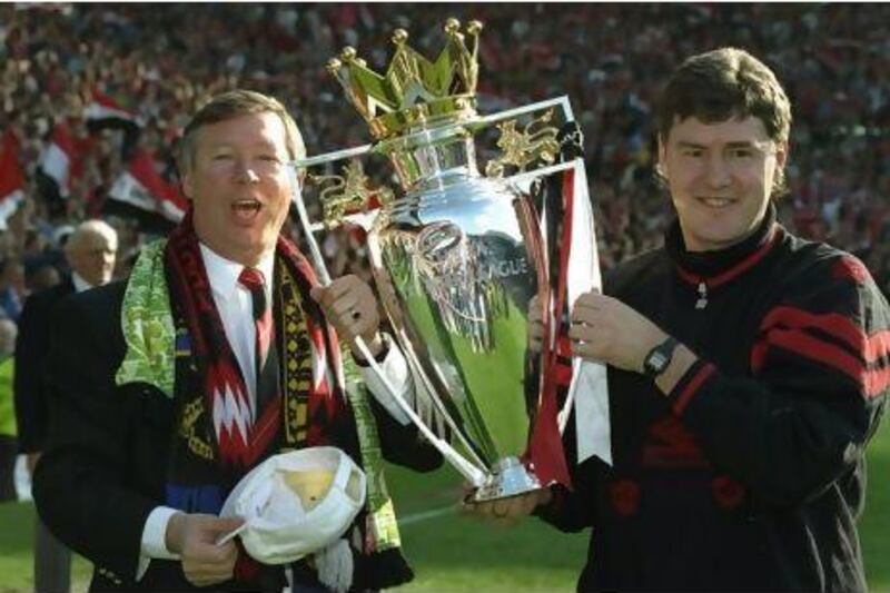 8 May 1994: Manchester United Manager Alex Ferguson (left) and Assistant Manager Brian Kidd hold the Premiership trophy after the match against Coventry City at Old Trafford in Manchester, England. The match ended in a 0-0 draw.  Mandatory Credit: ShaunBotterill/Allsport