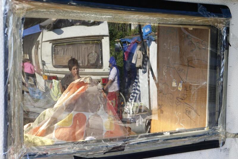 A Roma boy's reflection in the window of a caravan at an illegal camp in Croix, near Lille, northern France. Pascal Rossignol / Reuters