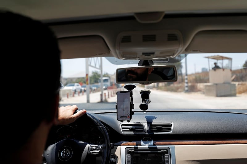 Mohammad Abdel Haleem, Chief Executive Officer of Doroob Technologies, uses Doroob Navigator application as he drives his car at an Israeli checkpoint in Ramallah, in the Israeli-occupied West Bank July 31, 2019. Picture taken July 31, 2019. REUTERS/Mohamad Torokman