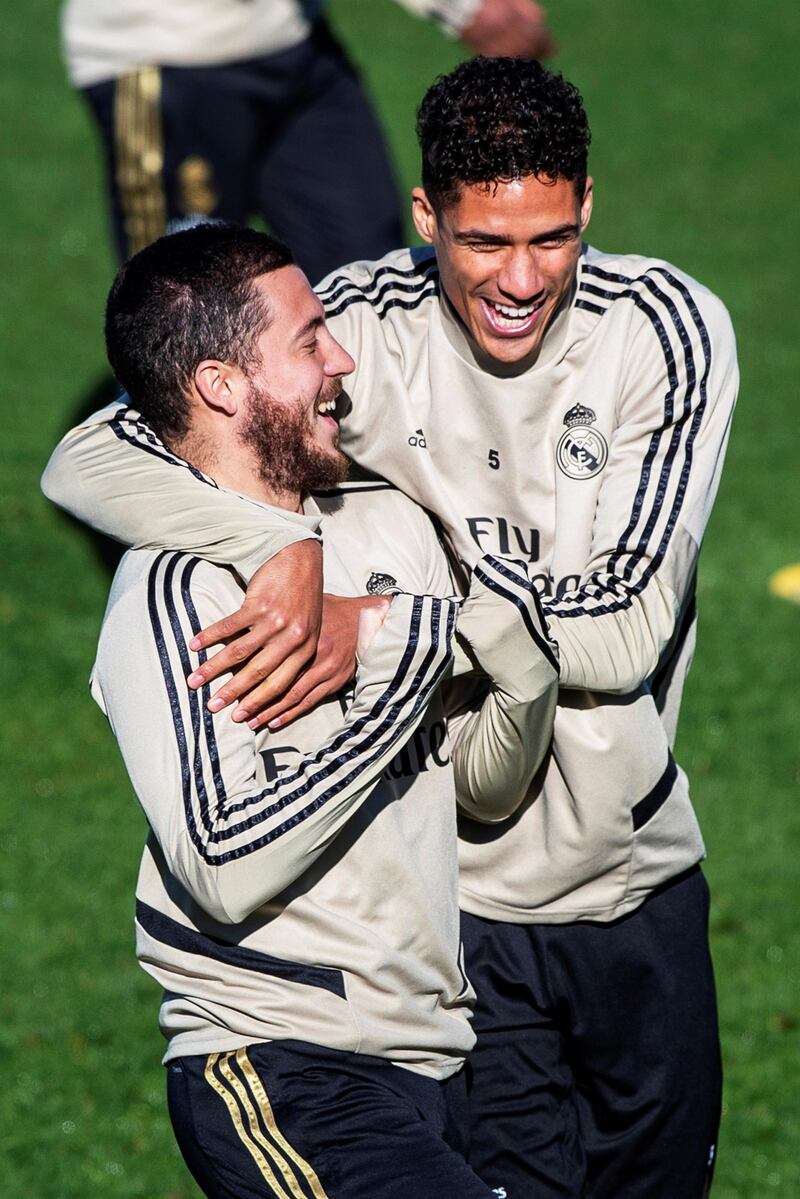 Eden Hazard and Raphael Varane share a joke during a Real Madrid training session. EPA