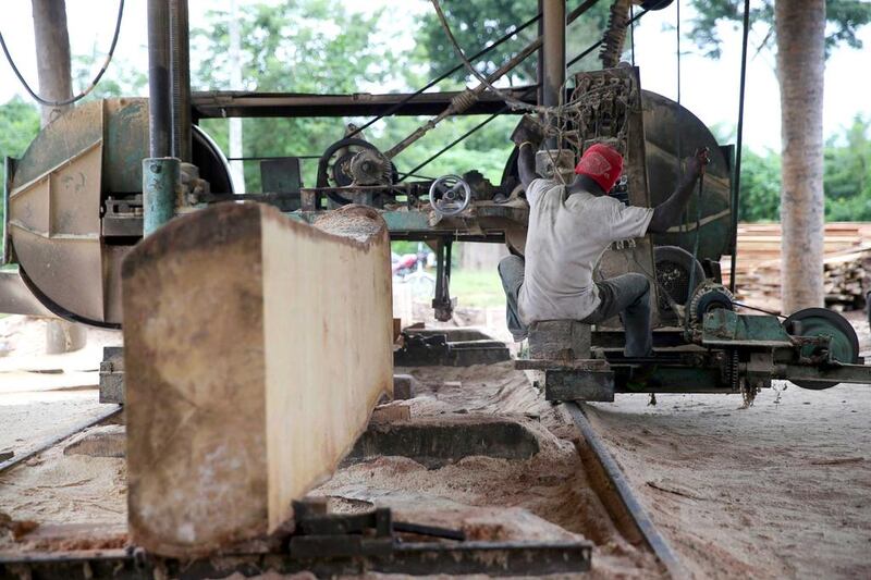 A labourer uses a milling machine at a sawmill near an unreserved forest in Igede-Ekiti township. For global logging companies, Nigerian forests appear to be an easy target as environmental regulations in the country are rarely enforced. Akintunde Akinleye / Reuters