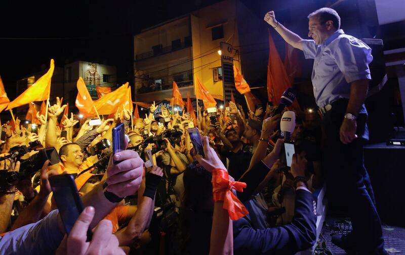 Free Patriotic Movement leader Gebran Basil celebrates on stage with supporters after the party's results in the parliamentary elections, early on May 7, 2018 in the Lebanese coastal town of Batroun.  Ibrahim Chalhoub / AFP