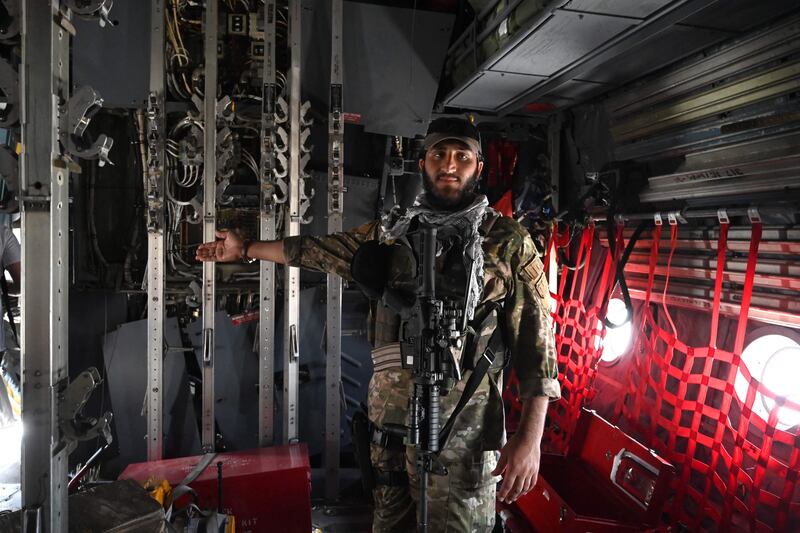 A Taliban special forces fighter seen inside an Afghan Air Force aircraft abandoned at Kabul airport.
