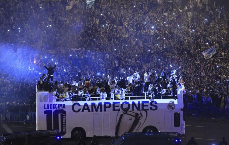 Real Madrid players celebrate with their fans their 10th European title on Saturday night at Cibeles Square in Madrid. Alberto Martin / EPA / May 24, 2014
