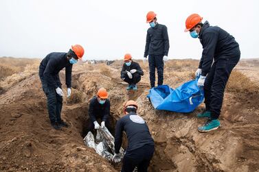 The team exhuming a dead body in Raqqa on December 21 2019. Thibault Lefébure for The National
