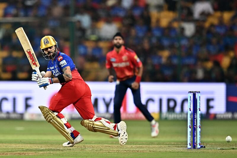 Royal Challengers Bengaluru's Virat Kohli watches the ball after playing a shot during the Indian Premier League (IPL) Twenty20 cricket match between Royal Challengers Bengaluru and Punjab Kings at the M.  Chinnaswamy Stadium in Bengaluru on March 25, 2024.  (Photo by Idrees MOHAMMED  /  AFP)  /  -- IMAGE RESTRICTED TO EDITORIAL USE - STRICTLY NO COMMERCIAL USE --