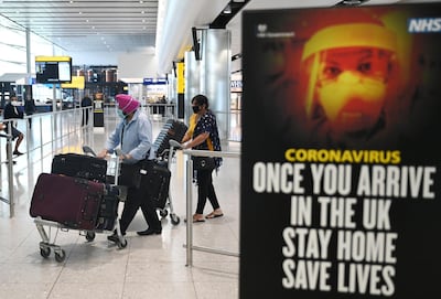 epa08397431 Passengers wear masks as they arrive at Heathrow Airport, in Britain, 02 May 2020.  Due to the coronavirus number UK daily flights has fallen and in some routes have been suspended. British Airways' parent company IAG announced it is set to cut up to 12,000 positions. Easyjet has laid off its 4,000 UK-based cabin crew for two months. Countries around the world are taking increased measures to stem the widespread of the SARS-CoV-2 coronavirus which causes the Covid-19 disease.  EPA/NEIL HALL