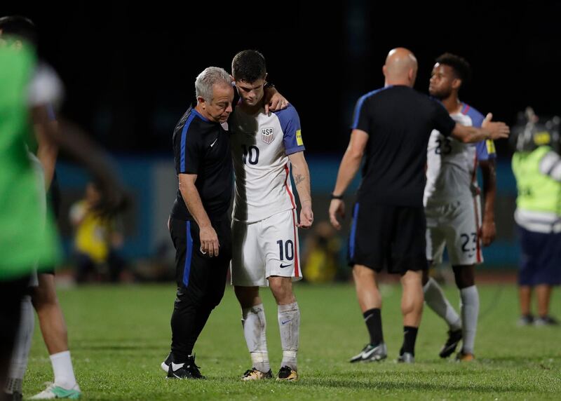 United States' Christian Pulisic, (10) is comforted after losing 2-1 against Trinidad and Tobago during a 2018 World Cup qualifying soccer match ����in Couva, Trinidad, Tuesday, Oct. 10, 2017. (AP Photo/Rebecca Blackwell)