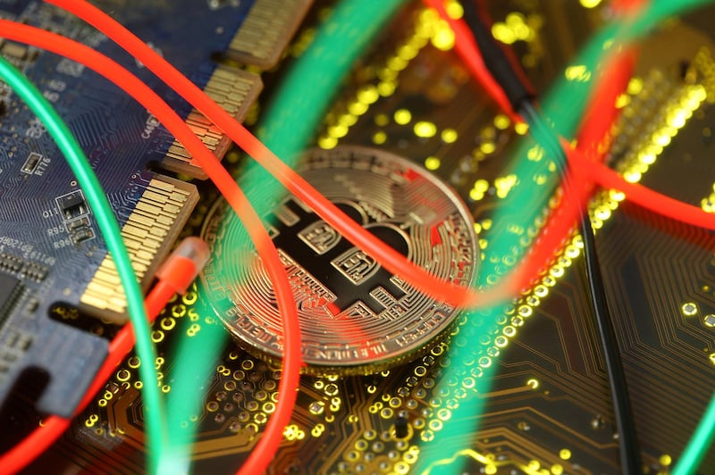 FILE PHOTO: Representation of the Bitcoin virtual currency standing on the PC motherboard is seen in this illustration picture, February 3, 2018. REUTERS/Dado Ruvic/Illustration/File Photo
