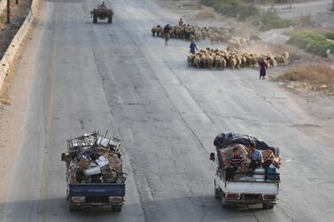 Syrian families from the southeastern Idlib province and the northern countryside of Hama fleeing battles with trucks loaded with their belongings. AFP