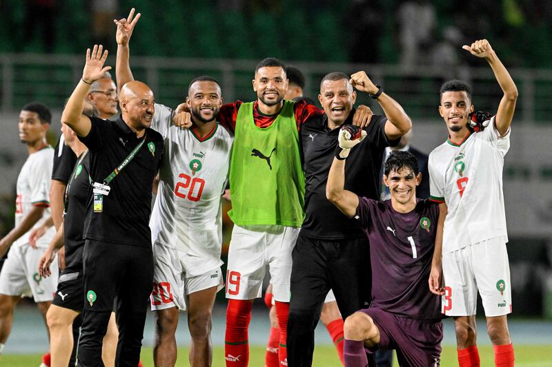 Morocco's players celebrate with assistant coach Rachid Benmahmoud after victory at the end of the Afcon match against Zambia in San Pedro. AFP