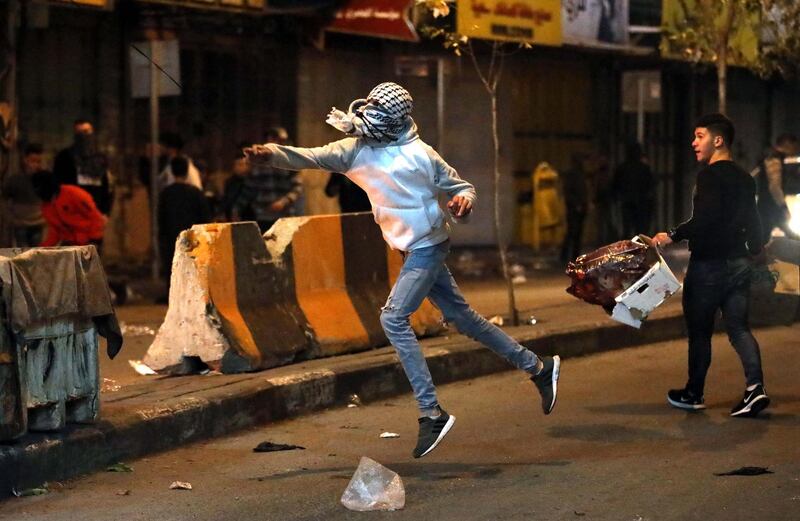 Palestinians throw stones during clashes with Israeli security forces in the wake of a protest against US President Donald J. Trump's Middle East peace plan to solve the conflict between Palestinians and Israel, near the West Bank City of Hebron.  EPA