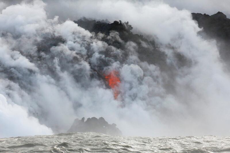 Lava flows into the Pacific Ocean southeast of Pahoa during ongoing eruptions of the Kilauea Volcano in Hawaii. Terray Sylvester / Reuters