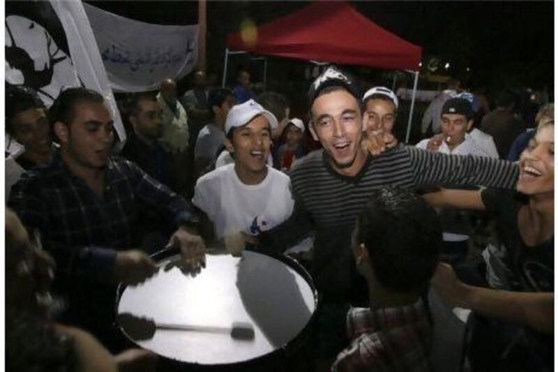 Ennahda party supporters dance during a rally near Tunis.