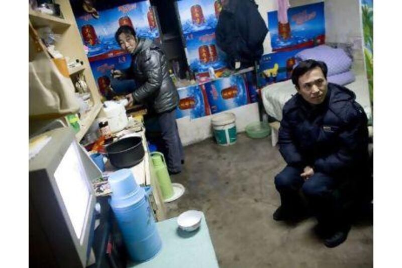 "I would like to move out, but we don't have enough money for a flat," says Yang Xiuyuan, who shares a room in one of Beijing's air-raid shelters with his wife, Xiao Genrong, left, and their daughter, Yang Fang, a saleswoman.
