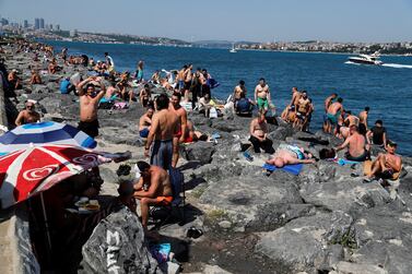 Men enjoy sunny weather by the Marmara Sea in Istanbul as restrictions in Turkey eased over the weekend following the coronavirus outbreak. Reuters