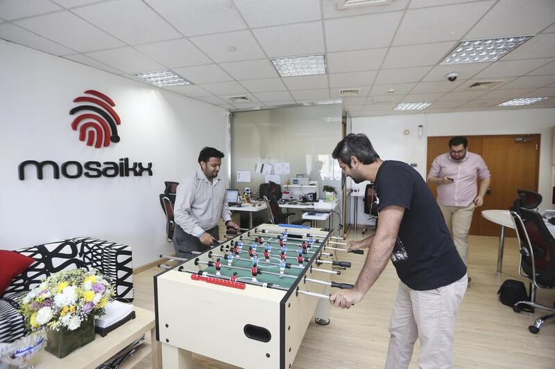 Employees play a round of foosball while on break at the Mosaikx office in Dubai. Sarah Dea / The National