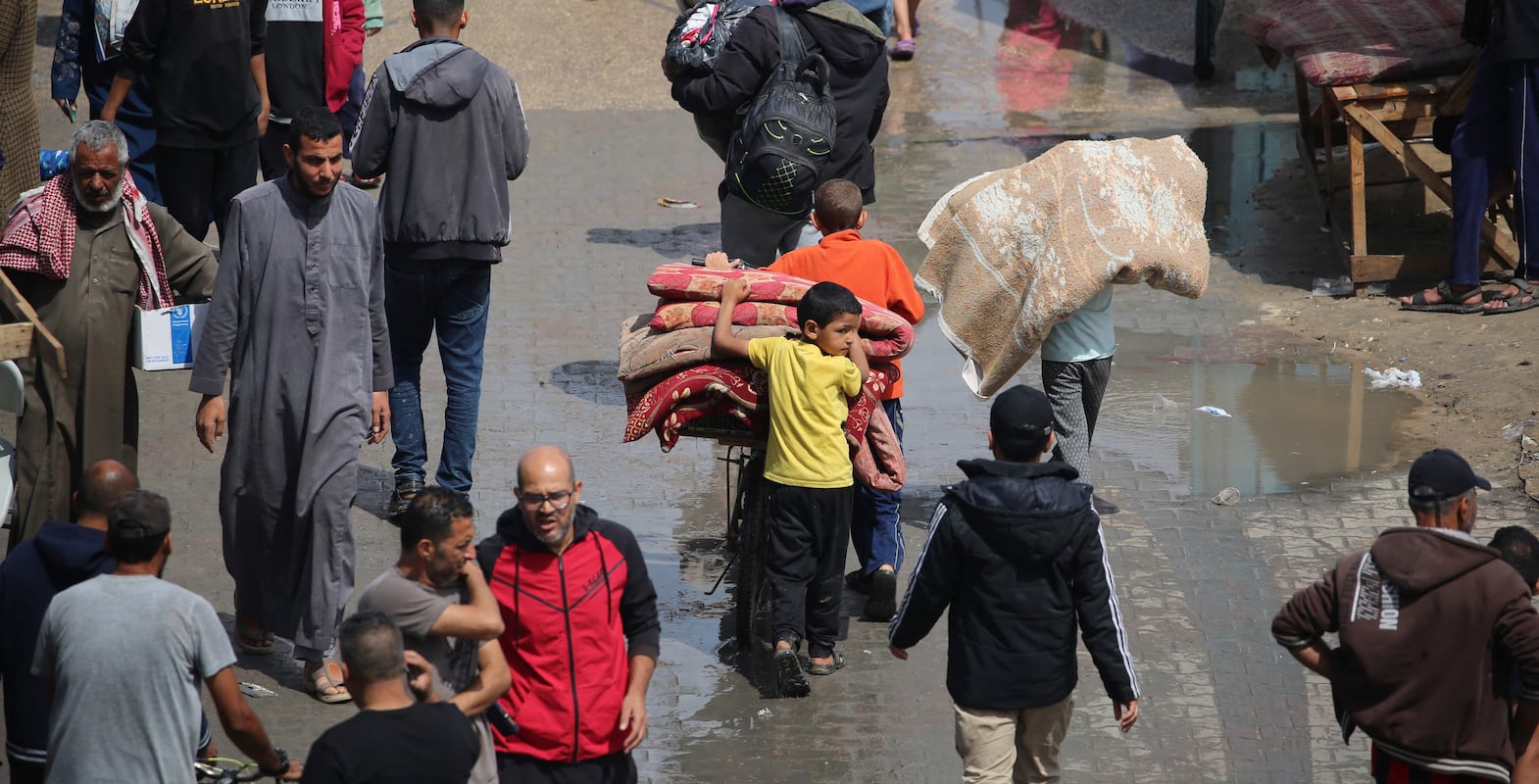 Displaced Palestinians in Rafah in the southern Gaza Strip carry their belongings as they leave following an evacuation order by the Israeli army on May 6, 2024, amid the ongoing conflict between Israel and the Palestinian Hamas movement.  AFP