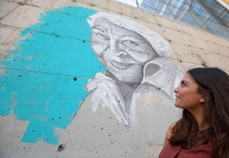 A young Lebanese woman admires the finished portrait in Beirut's downtown district. AFP