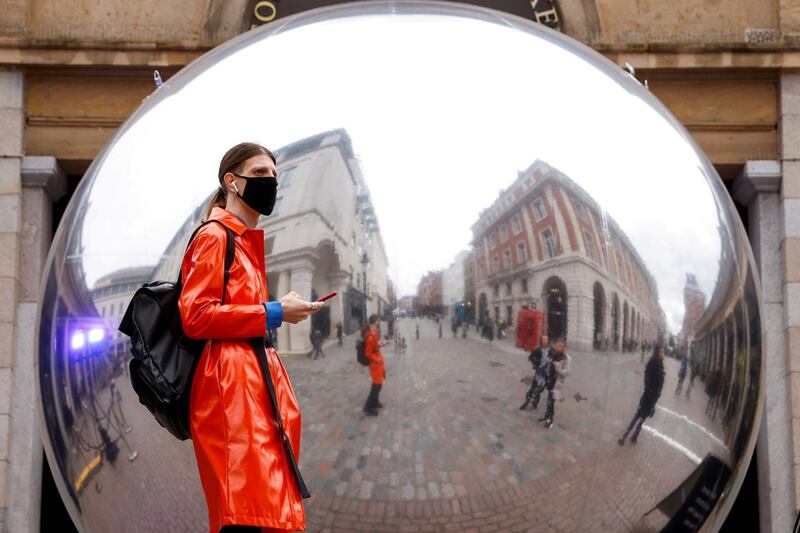 A person is reflected in an art work entitled "A=V" by Ben Cullen Williams in Covent Garden, London, Britain. Reuters