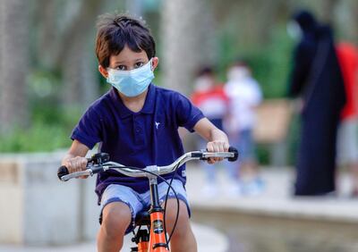 Abu Dhabi, United Arab Emirates, October 26, 2020.  The "new norm" of Covid-19 precautionary measures at Umm Al Emarat Park, Abu Dhabi, on a Monday afternoon.  It is a common sight to see children wearing face masks riding their bikes or scooters at the park.
Victor Besa/The National
Section:  NA
Reporter: