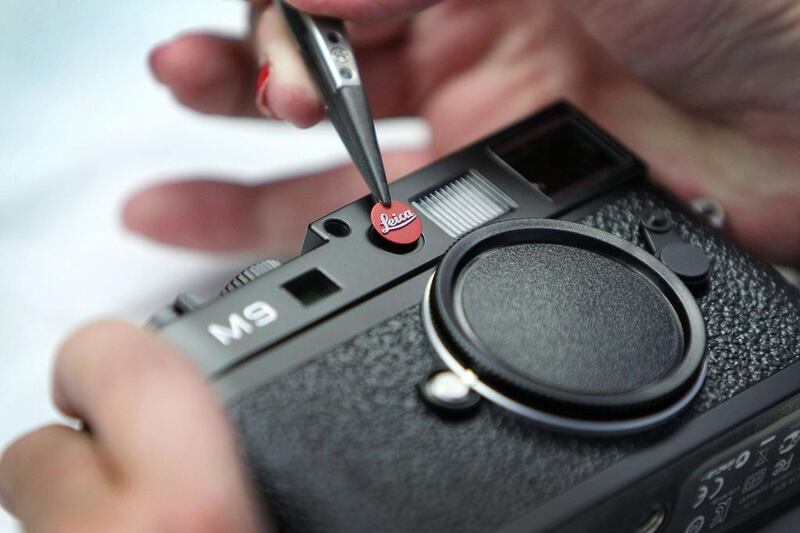 A mechanic fixes the Leica logo to an M9 camera at the production facility of Leica in Solms, western Germany. Daniel Roland / AFP