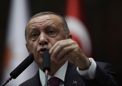 Turkish President Recep Tayyip Erdogan addresses his ruling party legislators at the Parliament, in Ankara, Wednesday, Oct. 30, 2019. Erdogan said Wednesday he would not recognize the nonbinding U.S. House of Representatives resolution to recognize the century-old mass killings of Armenians in Ottoman Turkey as genocide. (AP Photo/Burhan Ozbilici)