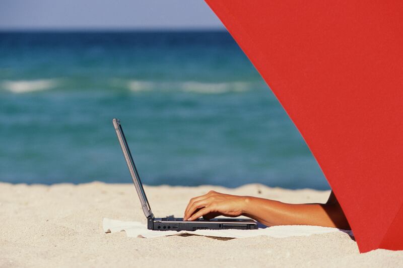 Using Laptop Computer on Beach --- Image by © Via Productions/Brand X/Corbis