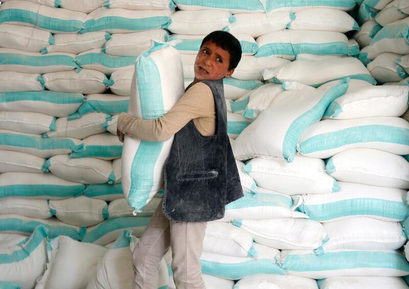 epa08212351 A boy unloads food rations provided by the World Food Programme (WFP) at an aid distribution center in Sana'a, Yemen, 11 February 2020 (Issued 12 February 2020). According to reports, international donors have warned that humanitarian assistance could be scaled-down to the Houthi-held northern areas of Yemen, accusing the Houthis of diverting food assistance from the hungriest people of war-ridden Yemen. Over 24 million people are in desperate need of humanitarian aid due to a five-year armed conflict between the Saudi-backed Yemeni government and the Houthis.  EPA/YAHYA ARHAB