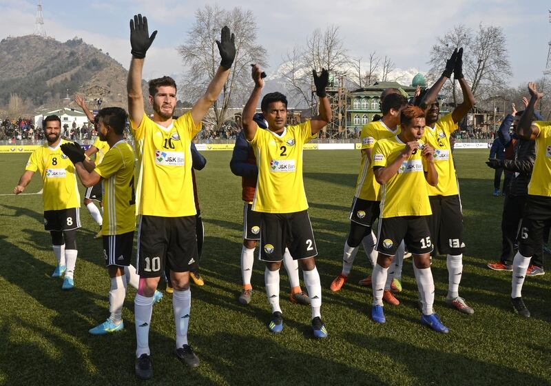 In this photo taken on January 28, 2019, Real Kashmir's players wave to fans after winning their I-League club football match against Chennai City FC at the Tourist Reception Centre football ground in Srinagar. Real Kashmir is the first club from the war-torn Himalayan region to make it into India's top football league. With the help of Scottish coach David Robertson, the Snow Leopards have emerged as serious title contenders in their debut I-League season and on February 6 beat Gokulam Kerala 1-0 to go top of the table. - TO GO WITH Fbl-IND-unrest-KAshmir, FOCUS by Abhaya SRIVASTAVA
 / AFP / Tauseef MUSTAFA / TO GO WITH Fbl-IND-unrest-KAshmir, FOCUS by Abhaya SRIVASTAVA
