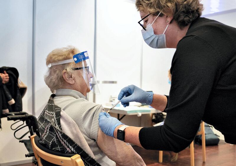 An elderly woman receives a vaccination against the novel coronavirus (Covid-19) in Aalborg, Denmark, on January 18, 2021 as the vaccination of the last citizens that are older than 65 years, who receive both personal care and practical assistance, is underway. (Photo by Henning Bagger / Ritzau Scanpix / AFP) / Denmark OUT