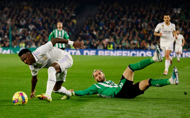 Real Madrid's Vinicius Junior in action with Real Betis' German Pezzella. Reuters