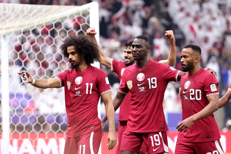 Akram Afif of Qatar celebrates with teammates after scoring his team's first goal. Getty Images