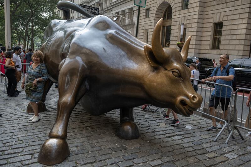 Visitors around the 'Charging Bull' statue near the New York Stock Exchange. Bloomberg
