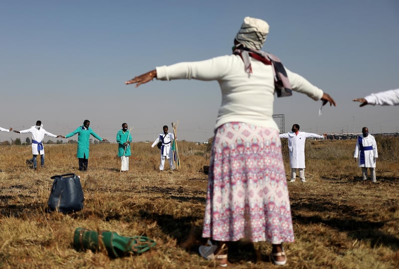 Congregants attend a church service at an open field in Soweto, South Africa. Reuters
