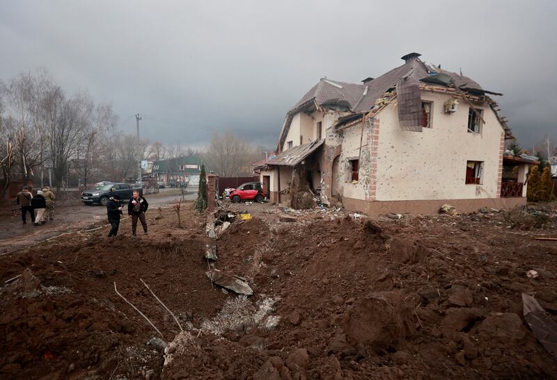 A crater in front of a house damaged by shelling in the village of Hatne. Reuters
