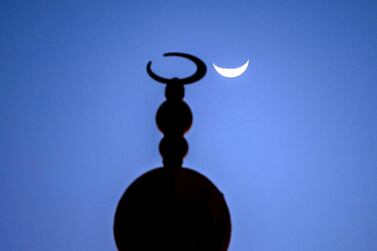 The crescent moon shows itself at the Sheikh Zayed Bin Sultan Al Nahyan Mosque at Al Bahia, Abu Dhabi, during Ramadan. Victor Besa / The National 