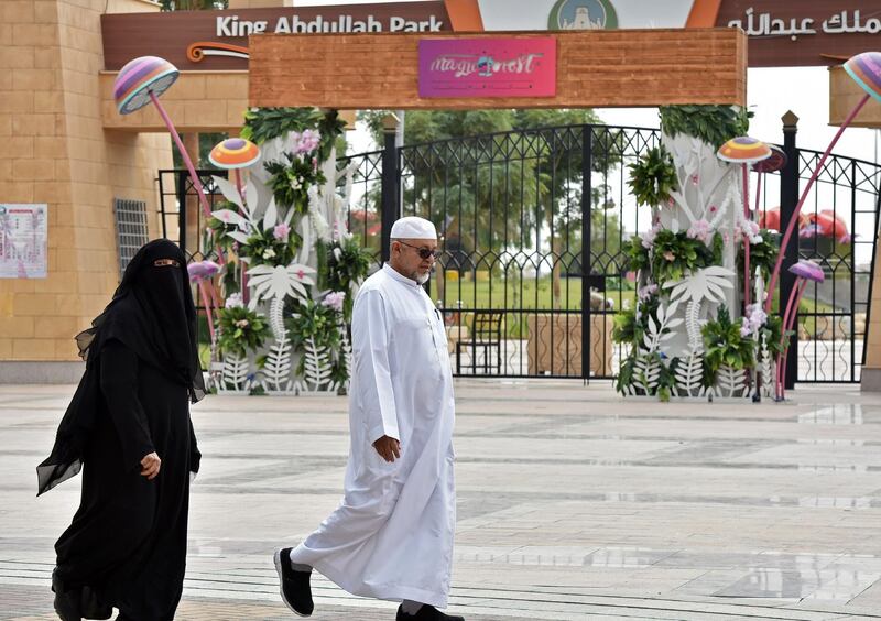 An elderly couple walk past the main gate of King Abdullah Park where a Yemeni man stabbed three performers during a live play in the Saudi capital Riyadh the previous day, according to police. AFP