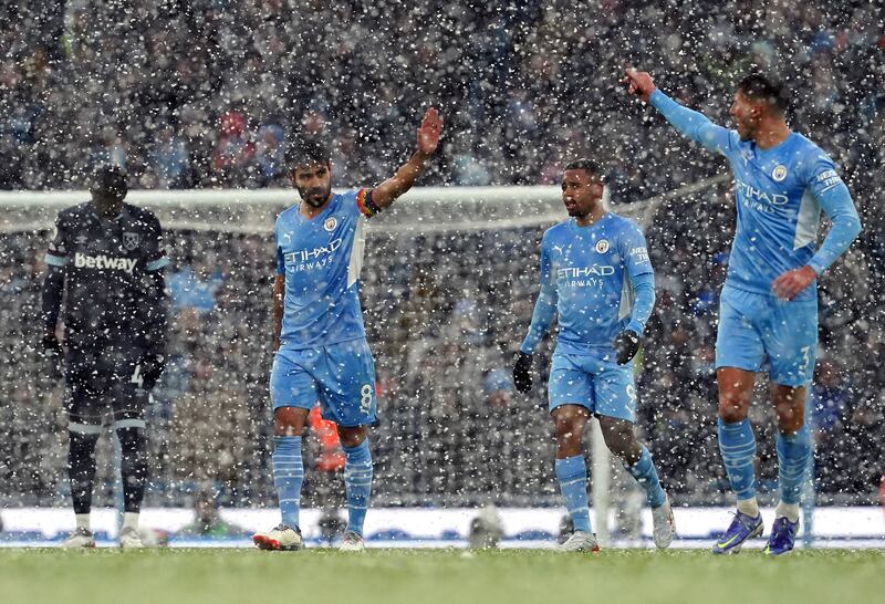 Ilkay Gundogan, left, celebrates scoring Manchester City's first goal against West Ham at the Etihad Stadium. PA