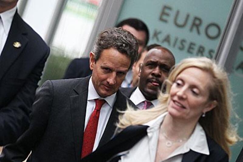 The US treasury secretary Timothy Geithner, centre, leaves the headquarters of the European Central Bank in Frankfurt yesterday. In addition to the bank’s president, Mario Draghi, Mr Geithner is scheduled to meet the Bundesbank president and a number of German government officials.