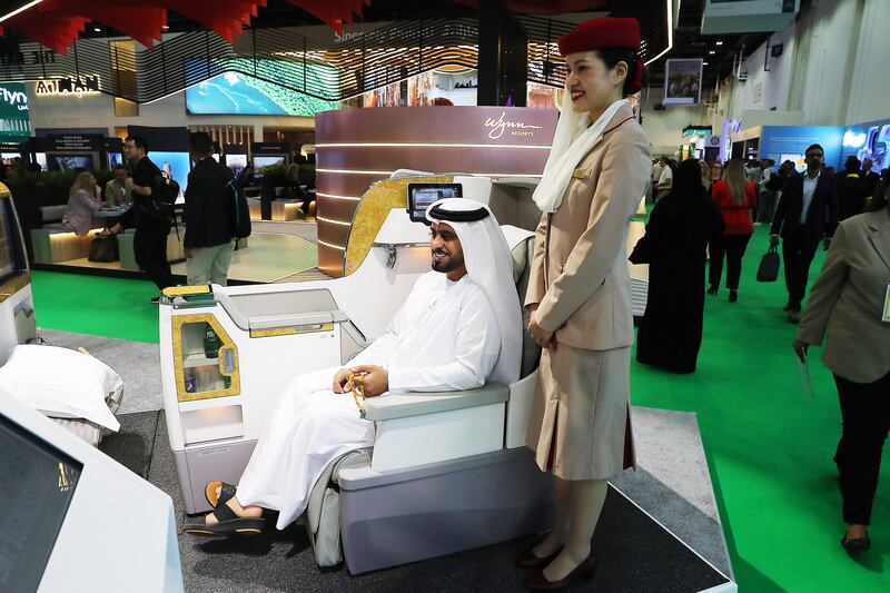 A visitor takes a seat at the Emirates airline stand during the Arabian Travel Market at the Dubai World Trade Centre. Pawan Singh / The National