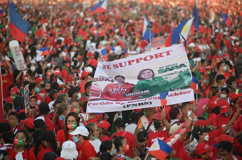 Supporters of Mr Marcos Jr and Sara Duterte, daughter of President Rodrigo Duterte and a vice presidential candidate, display a banner with their portraits during a campaign rally in Paranaque City. AFP
